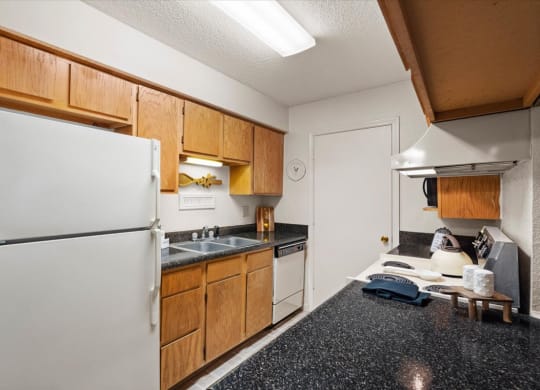 a kitchen with a refrigerator and a sink at Wind River Lodge, Kansas