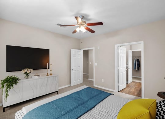 a bedroom with a bed and a ceiling fan at The Clairborne Apartment Homes, Texas