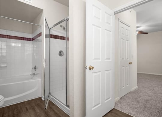 A bathroom with a shower and bath tub.
