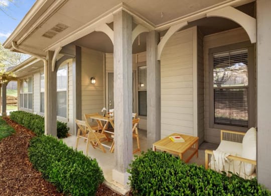 A covered patio with landscaping.