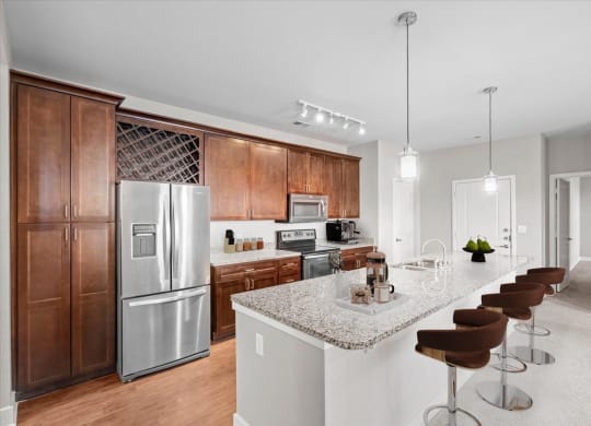 a kitchen with stainless steel appliances and a marble counter top