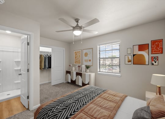 a bedroom with a large bed and a ceiling fan