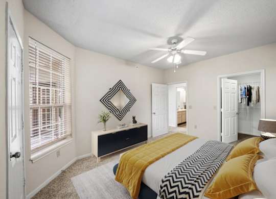 Bedroom With Ceiling Fan at The Claremont Apartment Homes, Overland Park
