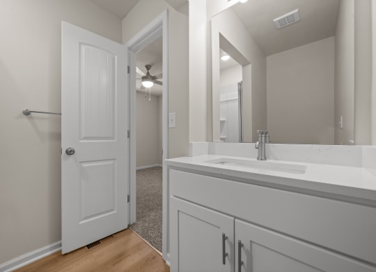 a bathroom with a large mirror and a white sink