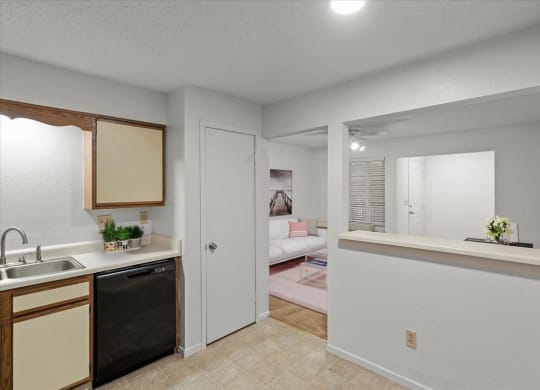 a kitchen with a view of a living roomat Millcreek Woods Apartments, Olathe, Kansas