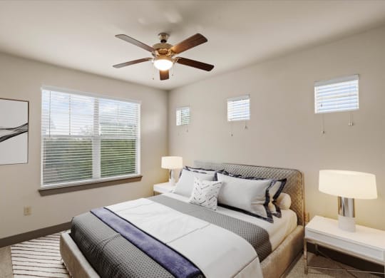 a bedroom with a large bed and a ceiling fan