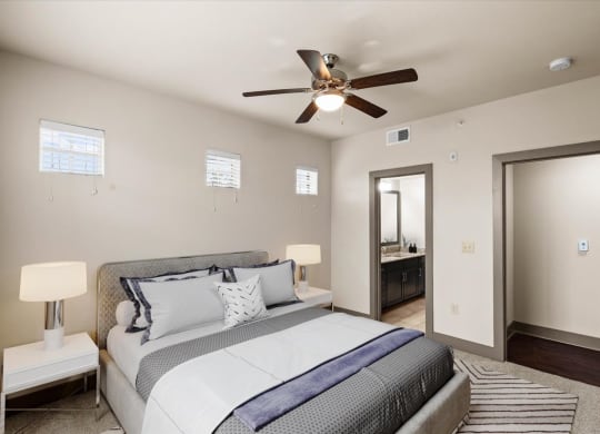 a bedroom with a large bed and a ceiling fan