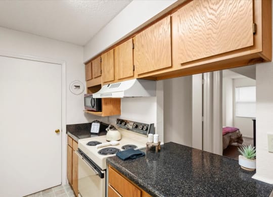 a kitchen with a counter top and a stove at Wind River Lodge, Lenexa, Kansas