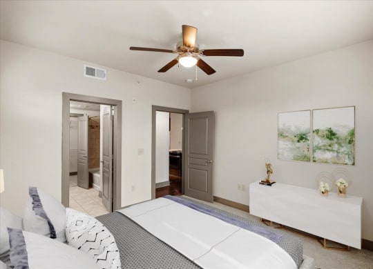 a bedroom with a large bed and a ceiling fan