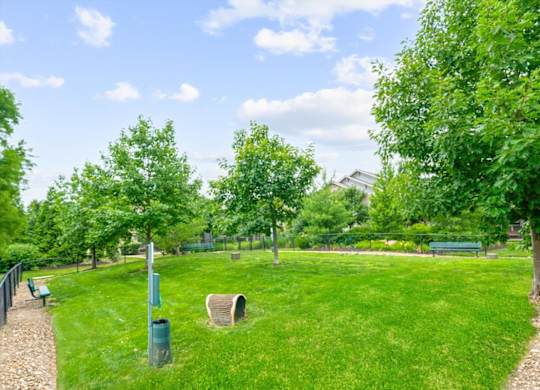 A park with a green lawn and trees.