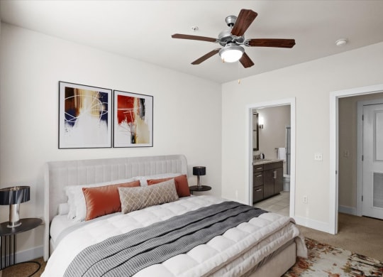 a bedroom with a bed and a ceiling fan