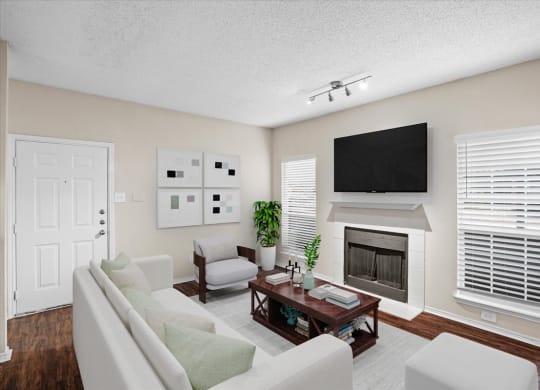 a living room with a fireplace and a tv above it at Creekview Apartment Homes, Dallas