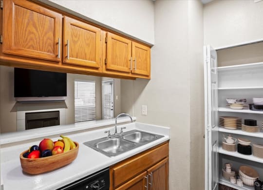a kitchen with a sink and a refrigerator at Creekview Apartment Homes, Dallas, Texas