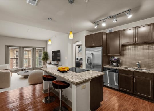 kitchen and living room at the district flats apartments in lenexa, ks