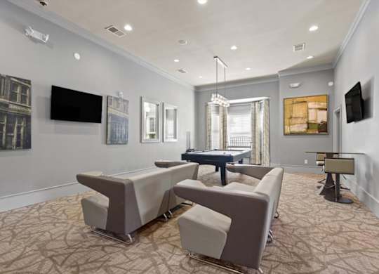 a living room with couches and a ping pong table at Stonepost Crossing Apartments, Overland Park, Kansas