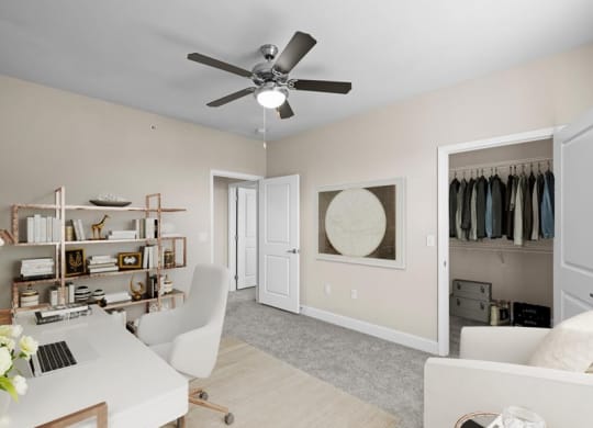 an office with a ceiling fan and a closet