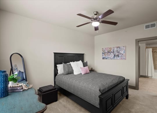 a bedroom with a bed and a ceiling fan