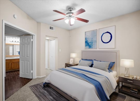 a bedroom with a bed and a ceiling fan at Creekview Apartment Homes, Texas