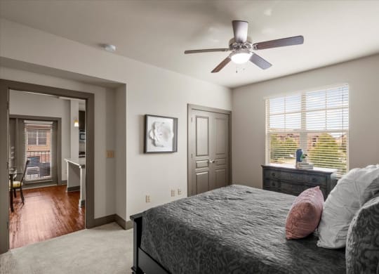 a bedroom with a large bed and a ceiling fan