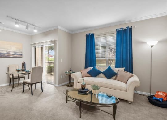 a living room with a couch and two chairs at The Clairborne Apartment Homes, Grand Prairie, TX, 75050