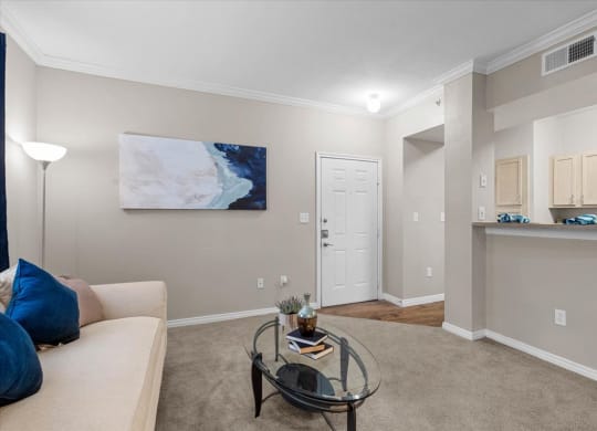 a living room with a couch and coffee table at The Clairborne Apartment Homes, Texas