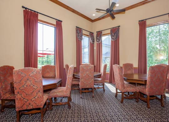 A meeting room and work from home space with large windows, tables and chairs.