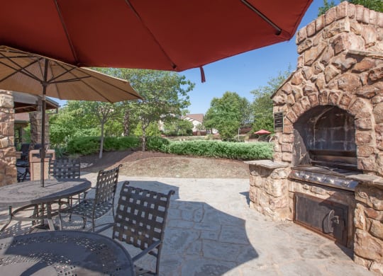Shaded seating at the pool grill station at Stonepost Ranch Apartments in Overland Park, KS.