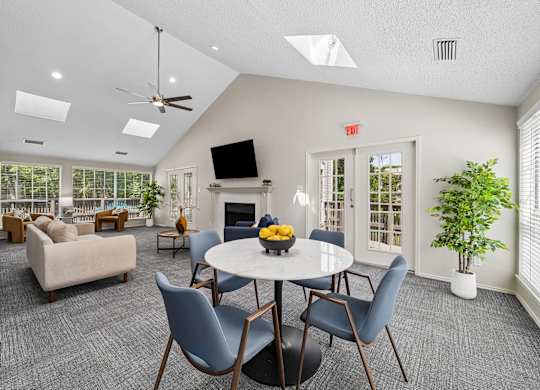 A living room with a grey carpet and a white ceiling.