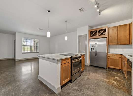 A kitchen with a white island and wooden cabinets.