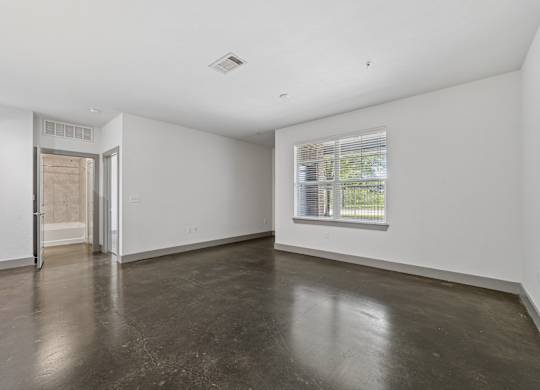 A room with a concrete floor and a window.