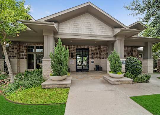 A building with a front yard and a walkway leading to the entrance.