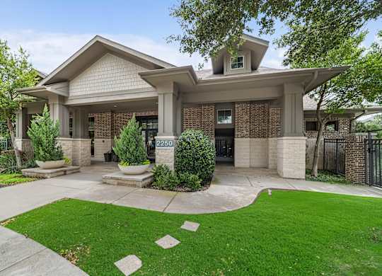 A house with a green lawn in front.