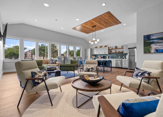 a living room with couches and chairs and a kitchen