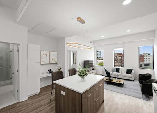 A modern kitchen with a white countertop and wooden cabinets.