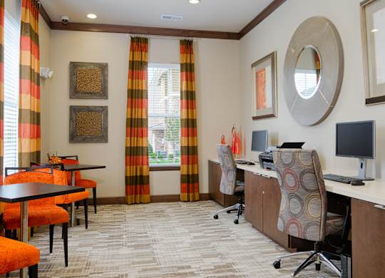 A room with a desk, chairs, and a computer at Residences at Prairiefire Apartment Homes, Overland Park
