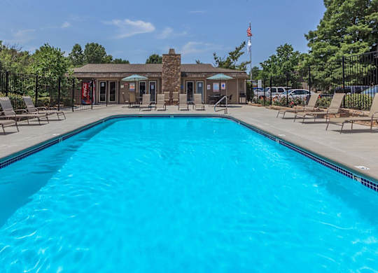 Swimming pool with lounge seating at Bristol Pointe Apartments in Olathe, Kansas.