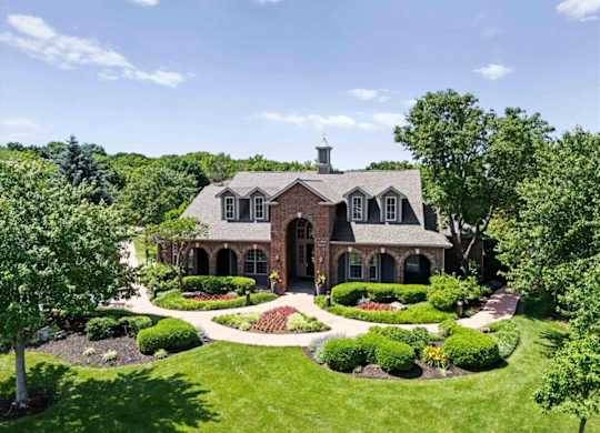 A large house with a landscaped front yard.