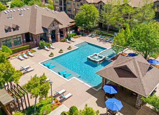 an aerial view of the pool at the resort on a sunny day