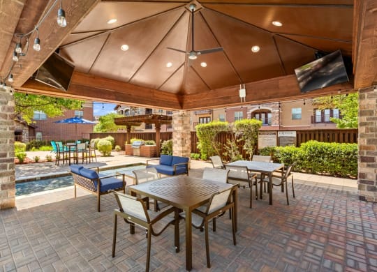 a patio with tables and chairs and a pool