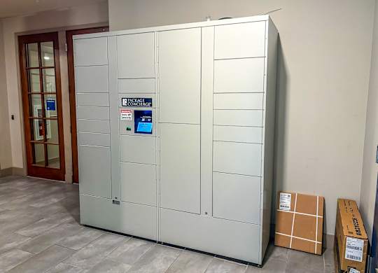 Secure package lockers at The Dorset Apartments with digital screen for convenient resident access.