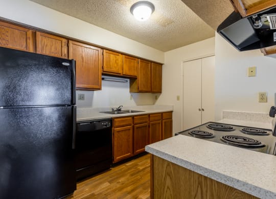 Black appliances and wooden cabientsat Coventry Oaks Apartments, Overland Park, KS, 66214