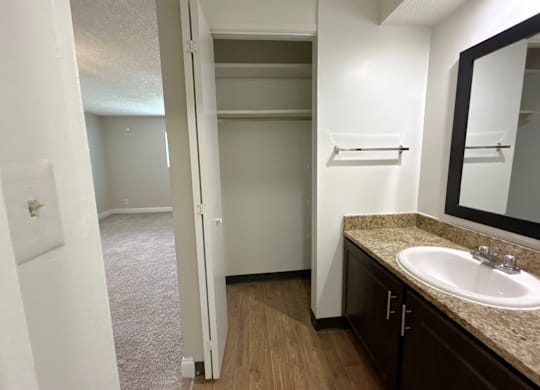 Classic Studio - Bathroom with a sink, mirror, and a closet.