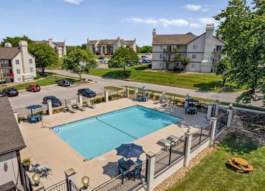 Elevated view of the outdoor swimming pool featuring lounge seating and community gathering areas.
