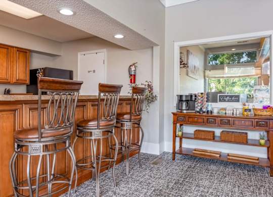 Resident clubhouse seating area with coffee station and community gathering space.