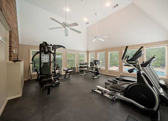 A spacious home gym with a variety of exercise equipment.