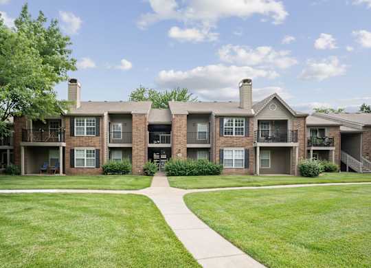 Apartment complex with a walkway in the front.