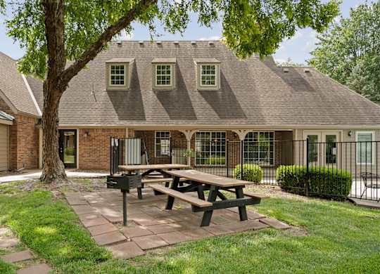 A house with a picnic table in front of it.