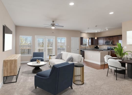 a living room and kitchen with a couch and chairs
