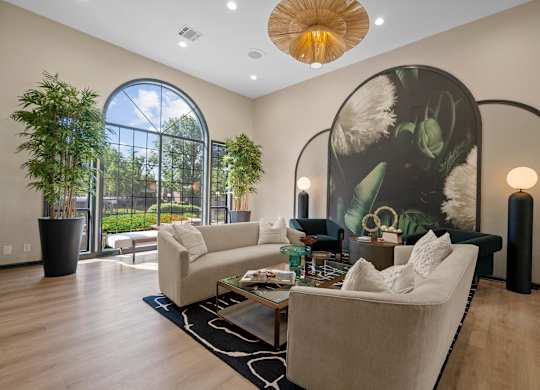 A living room with a large couch and a large painting on the wall.