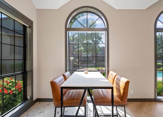 A dining room with a table and chairs.